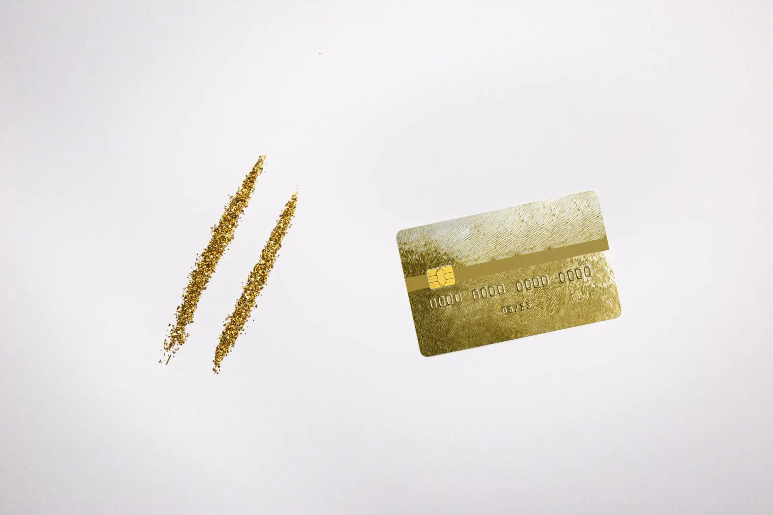 Golden dust representing cocaine and a credit card