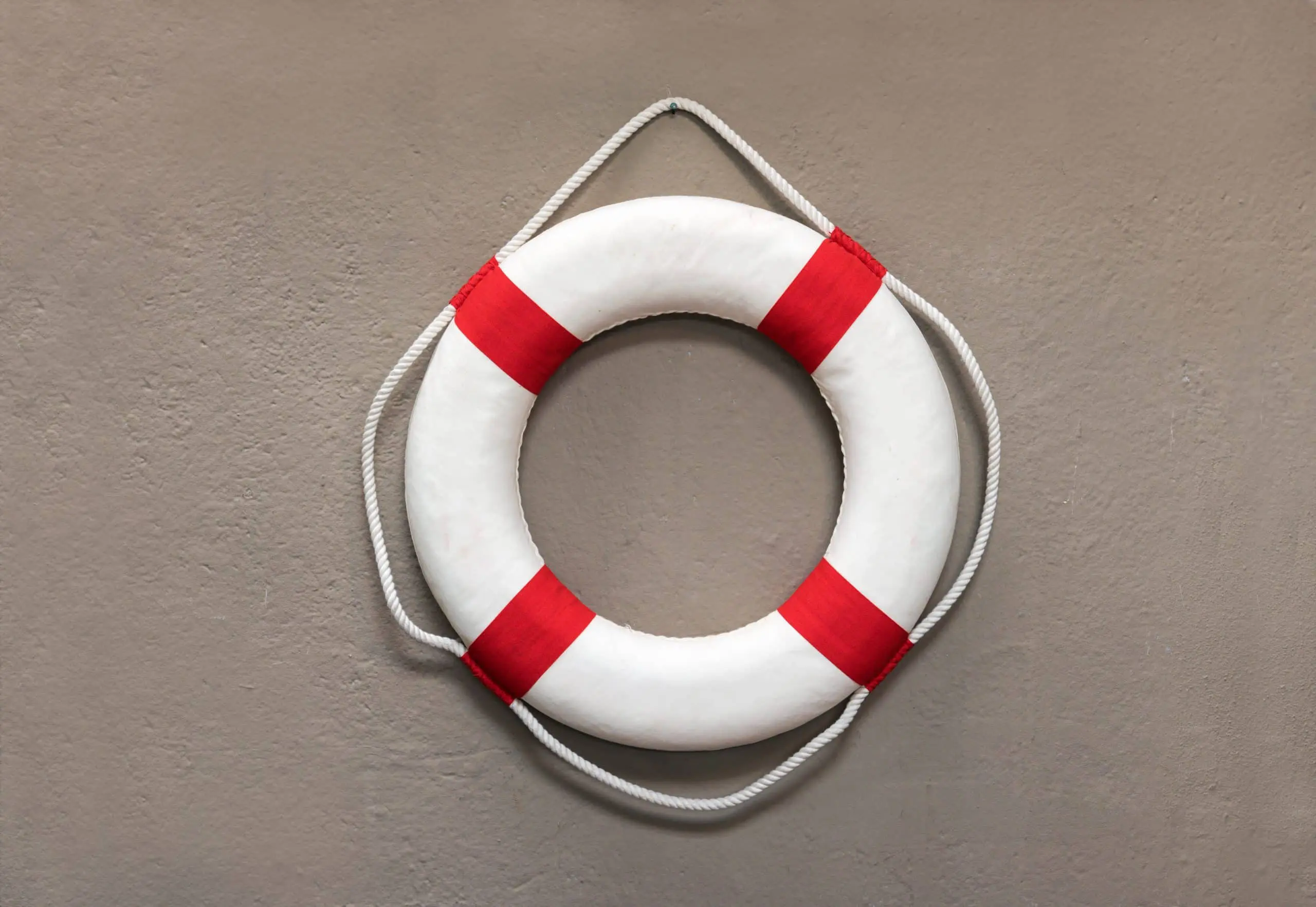 a white and red life preserver on a wall