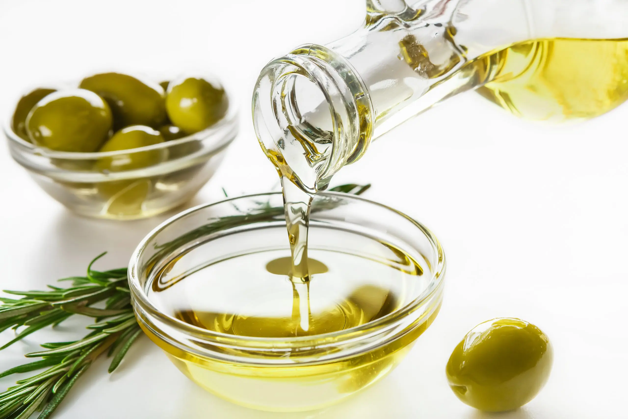 olive oil being poured into a bowl