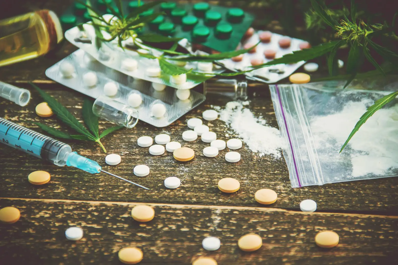 pills and syringe on a table