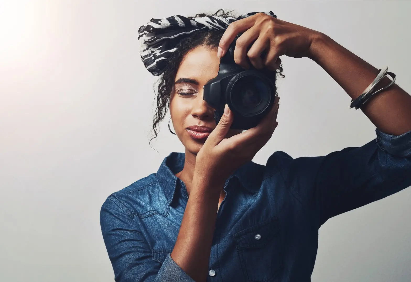 woman looking at us through her camera during National Hobby Month