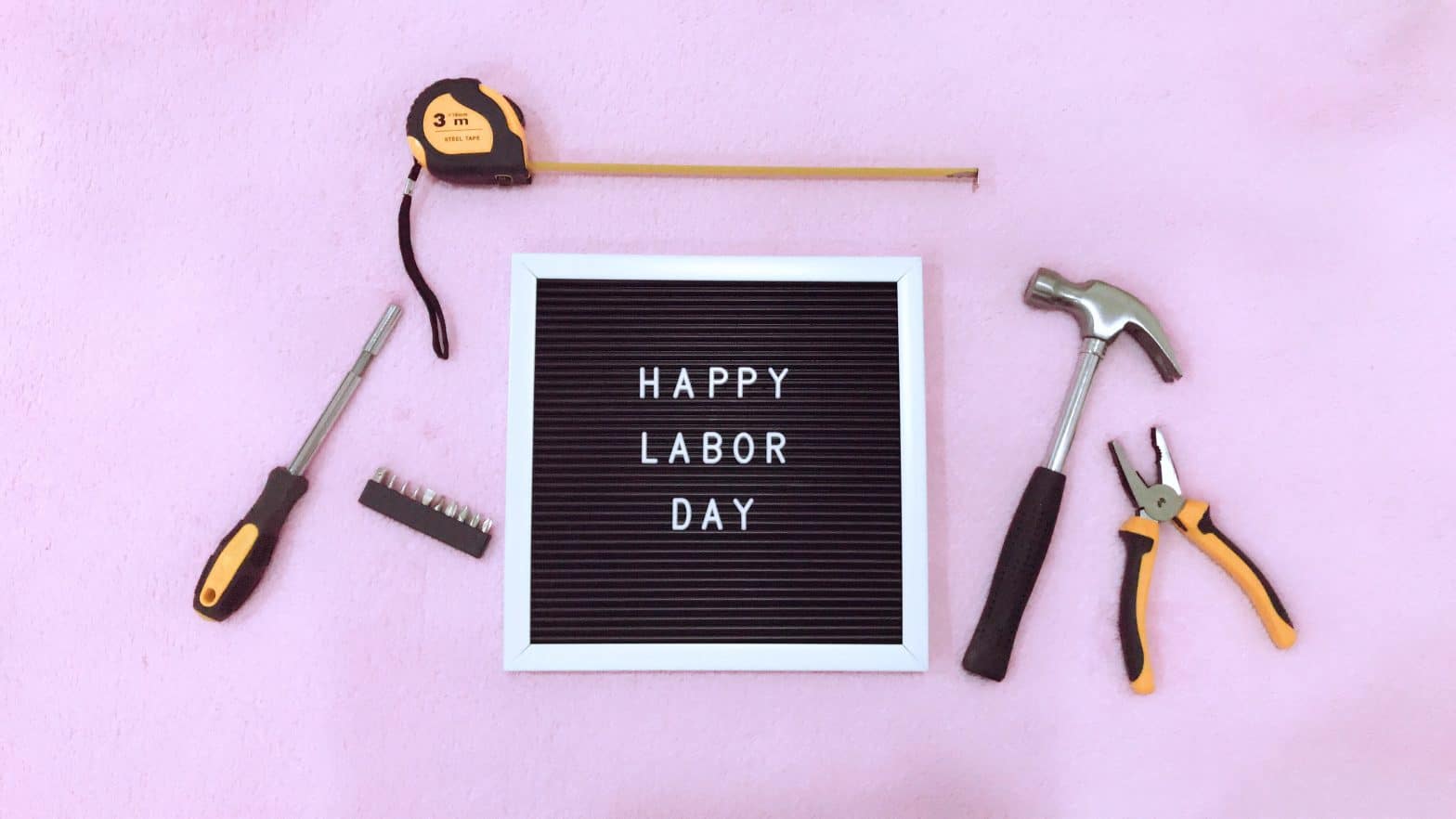 Happy Labor Day sign surrounded by tools