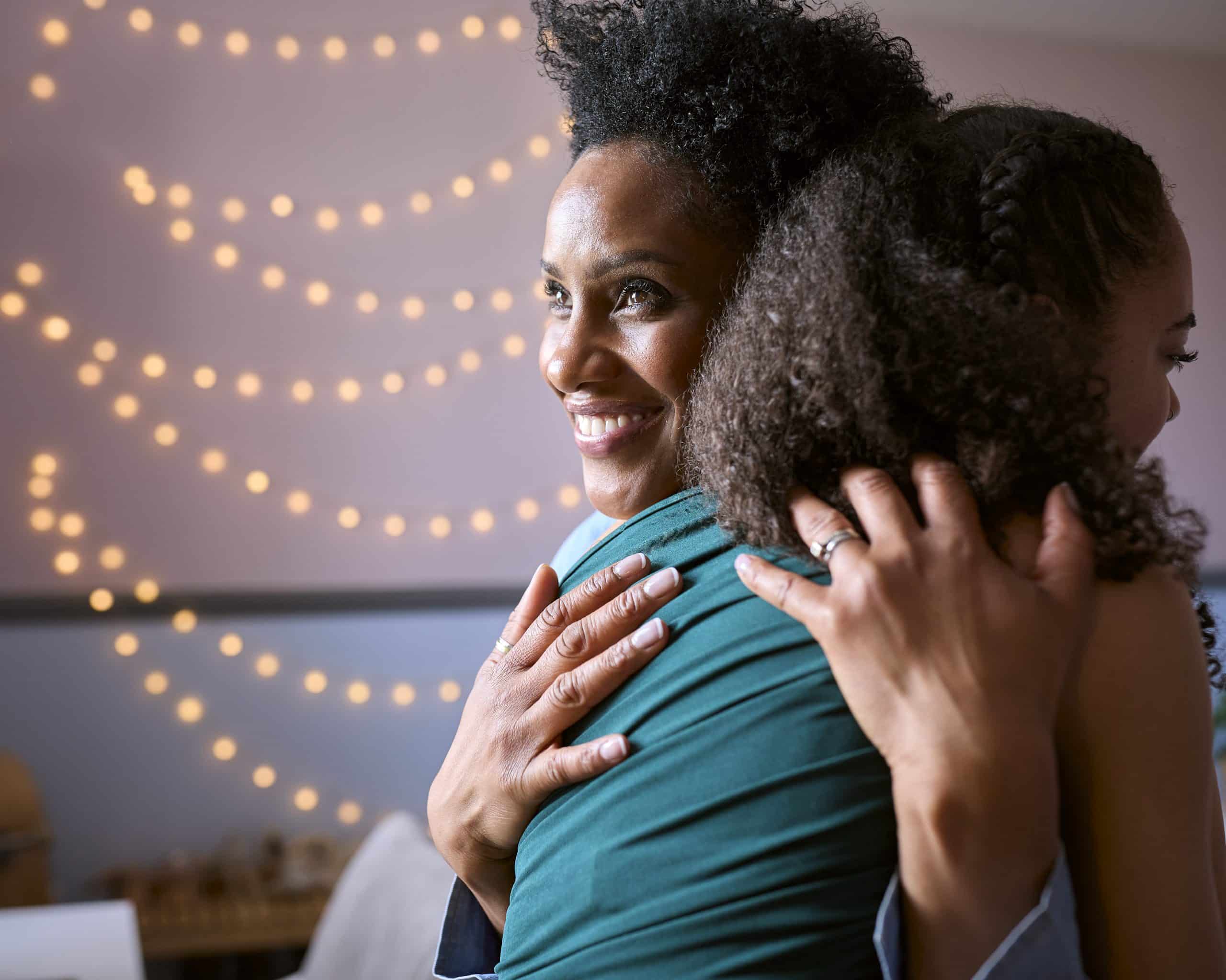 a woman hugging another woman